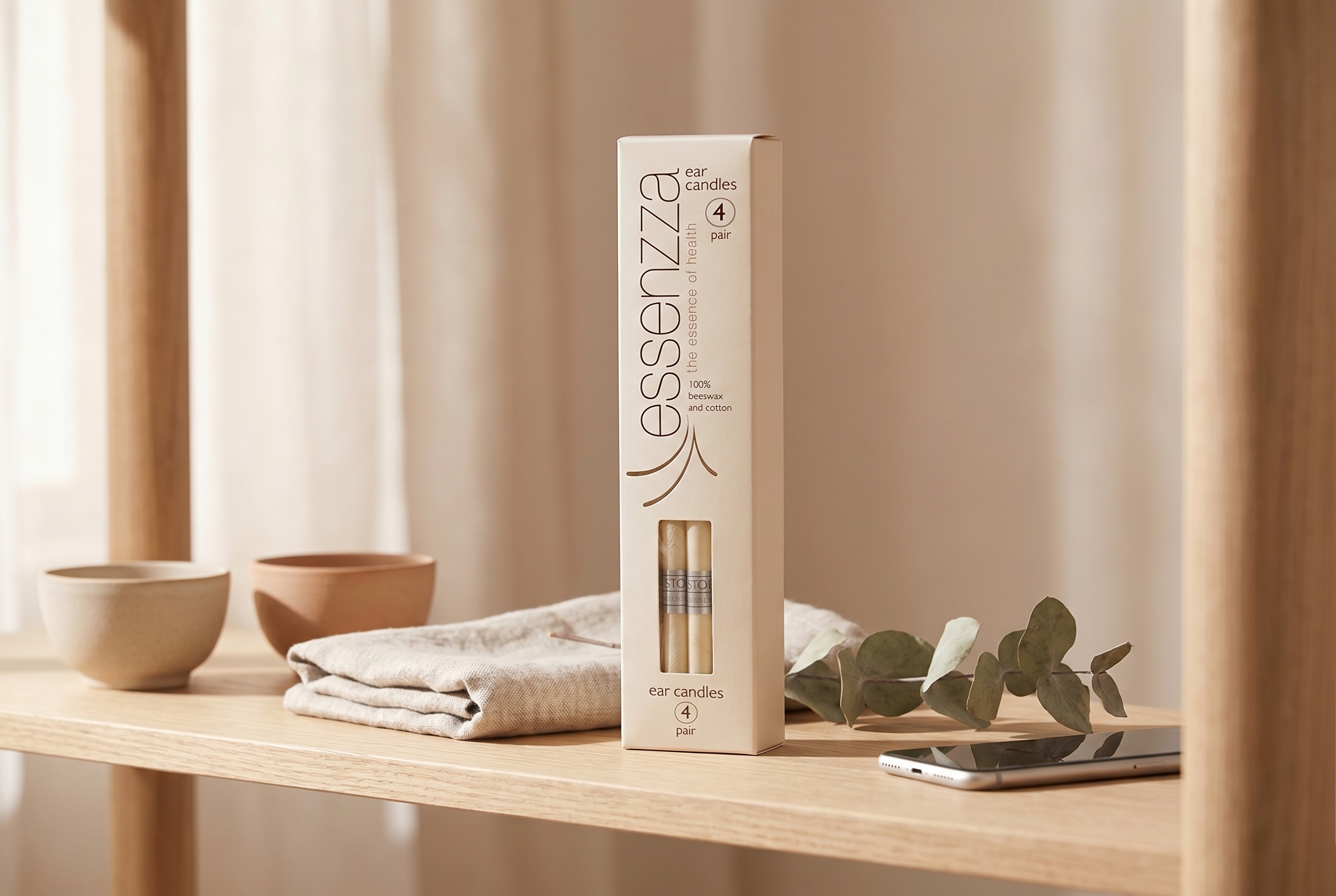 Essenzza Original ear candle pack on a shelf beside a switched-off phone — screen-free detox ritual