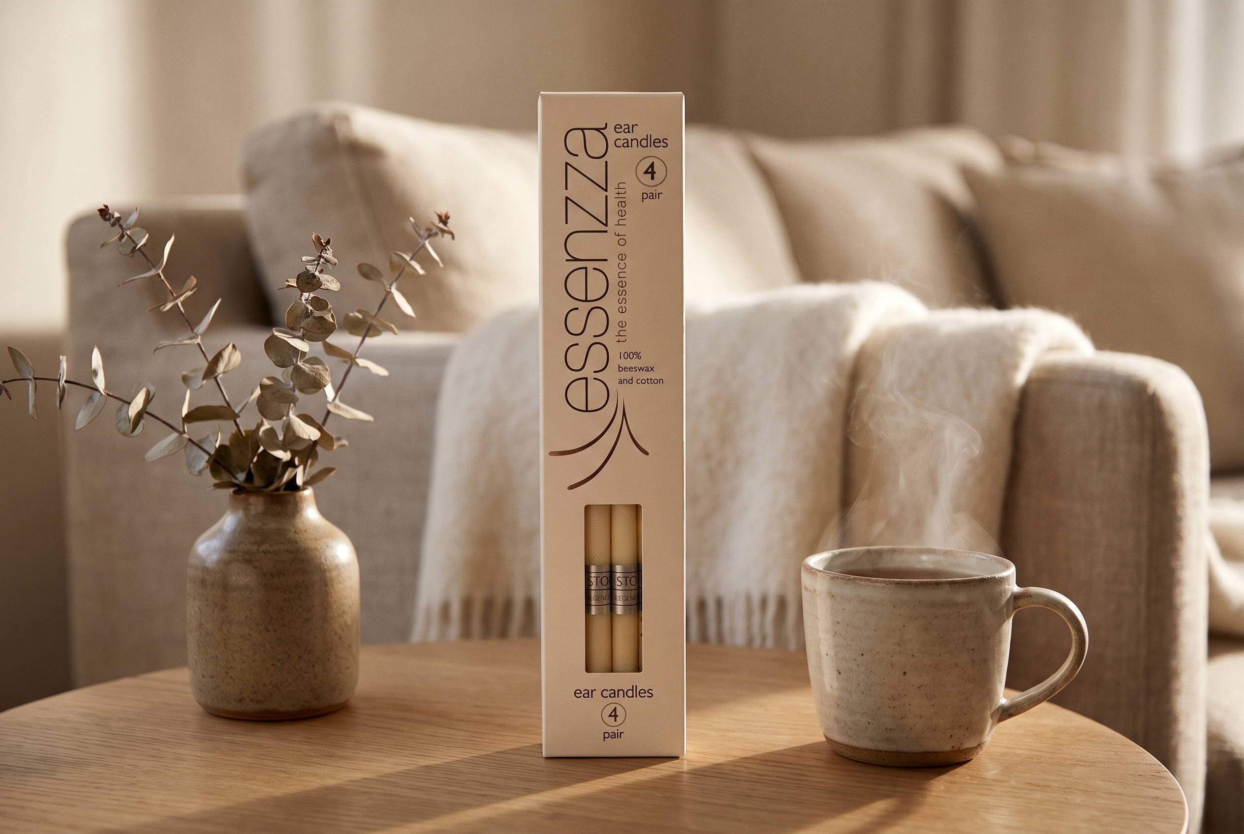 Essenzza Original ear candles pack still-life — cream carton on a warm-timber side table with dried eucalyptus