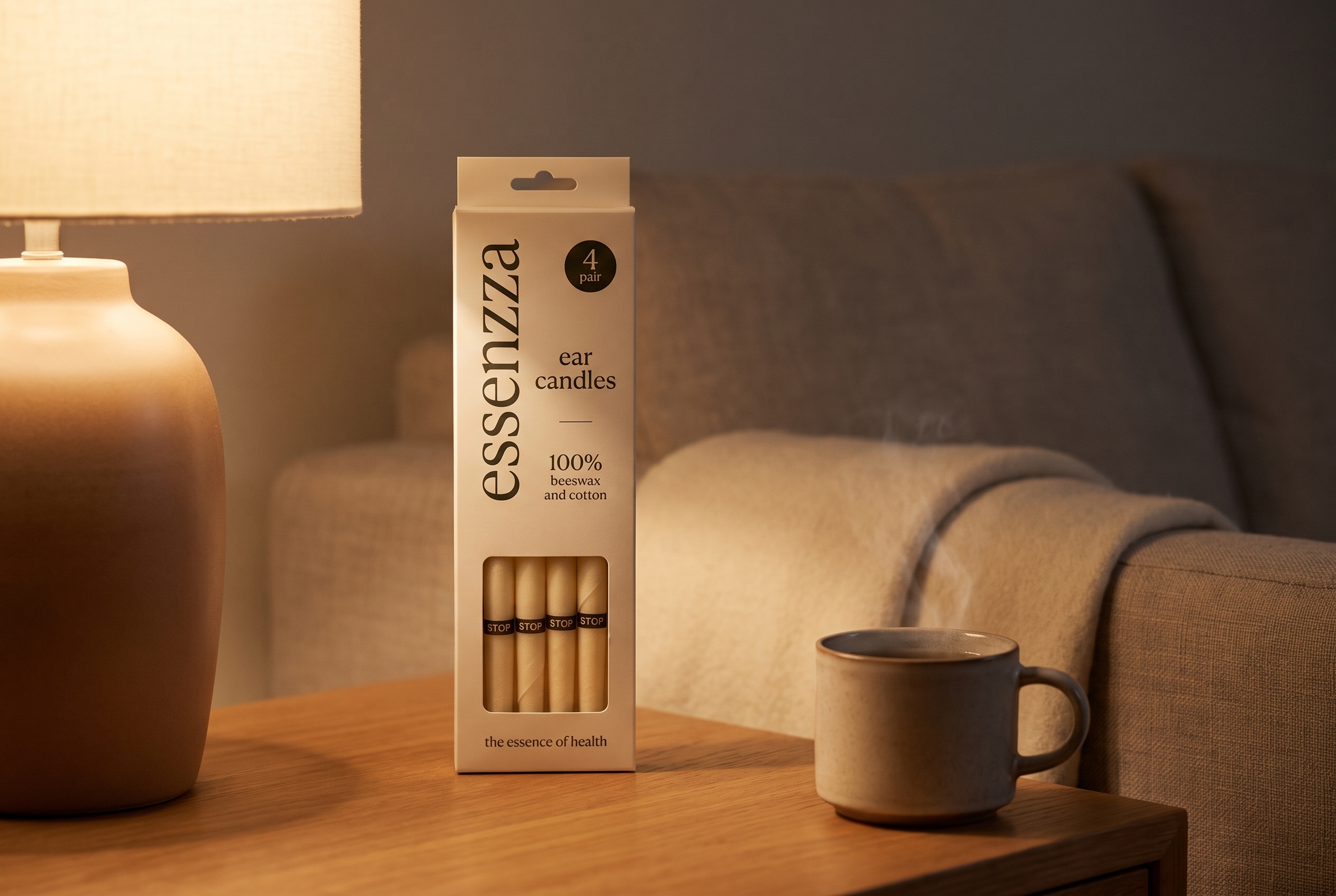 Essenzza Original ear candles pack still-life — cream carton beside a warm ceramic lamp at dusk